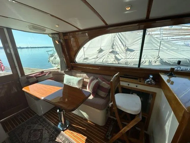 Slide: The Image of Interior of 2003 Hinckley Talaria 44 FB yacht with elegant seating and wooden finishes. - 4