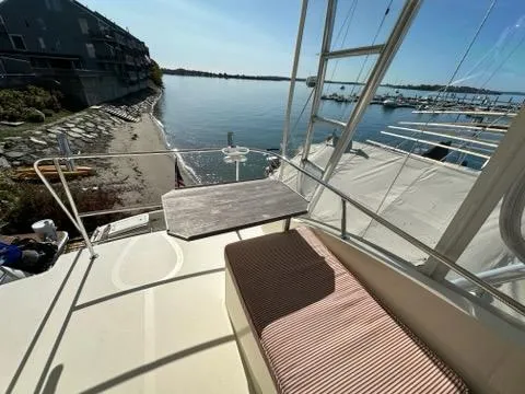 Slide: The Image of Hinckley Talaria 44 FB 2003 yacht deck with seating, overlooking serene waterfront view. - 40