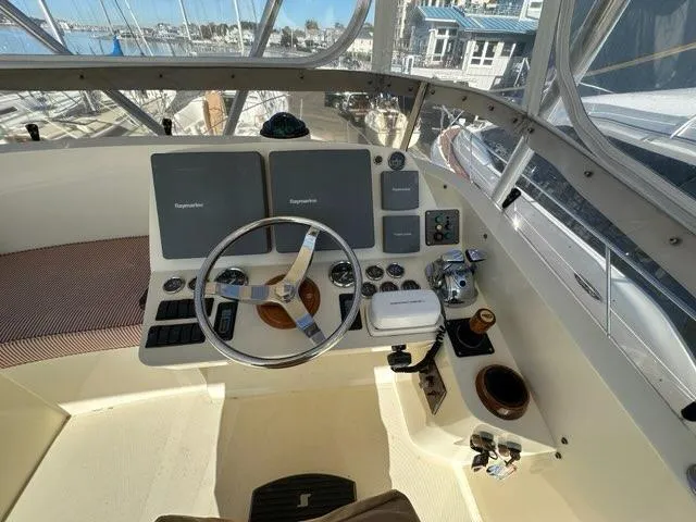 Slide: The Image of Helm of 2003 Hinckley Talaria 44 FB yacht with steering wheel and navigation controls. - 41