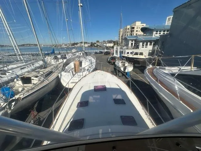 Slide: The Image of 2003 Hinckley Talaria 44 FB yacht docked among other boats in a marina. - 45
