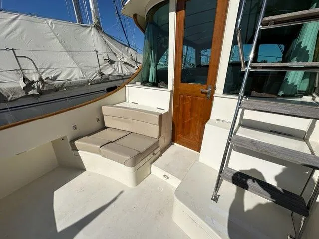 Slide: The Image of 2003 Hinckley Talaria 44 FB yacht deck with seating and wooden door. - 47
