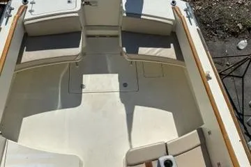 Slide: The Image of 2003 Hinckley Talaria 44 FB boat interior with beige seating and wooden accents. - 48