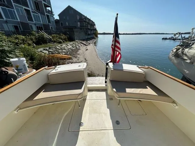 Slide: The Image of Hinckley Talaria 44 FB 2003 yacht with seating, American flag, and waterfront view. - 49