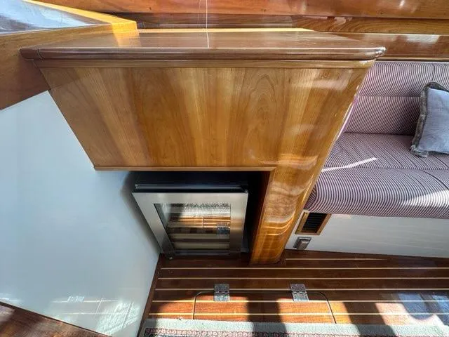 Slide: The Image of 2003 Hinckley Talaria 44 FB interior with wood finish and striped seating. - 5