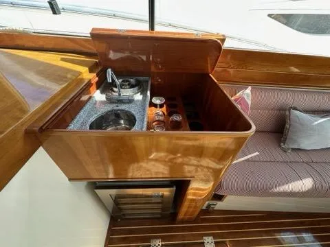 Slide: The Image of 2003 Hinckley Talaria 44 FB yacht interior with compact kitchen and seating area. - 6