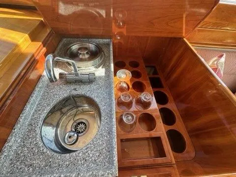 Slide: The Image of Luxury yacht galley with sink and glass holders, Hinckley Talaria 44 FB, 2003 model. - 7