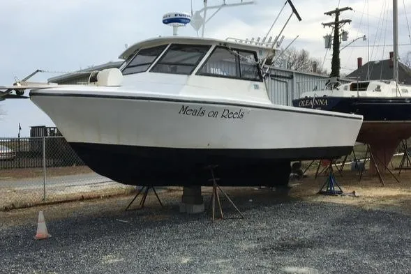 The Image of 1986 Island Hopper 30 boat named "Meals on Reels" on dry dock. - 0