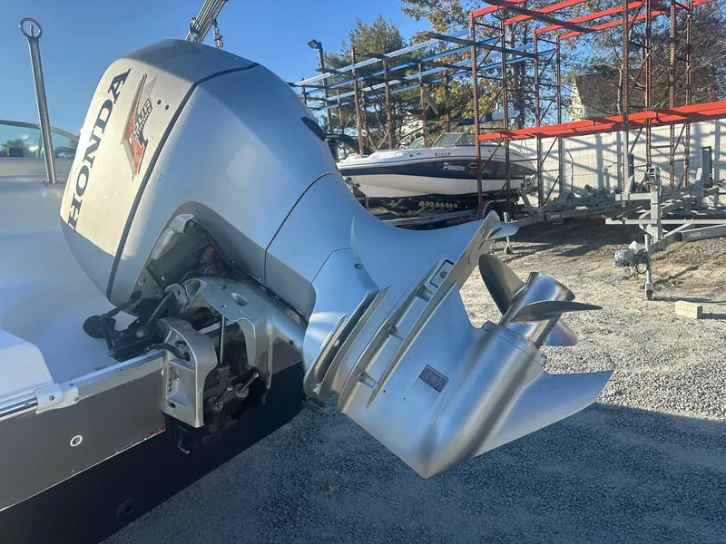 Slide: The Image of Honda outboard motor on 2012 Godfrey Hurricane 237 boat, parked on gravel. - 15