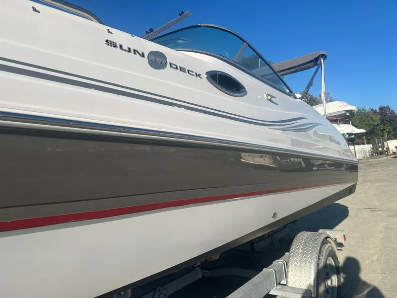 Slide: The Image of 2012 Godfrey Hurricane 237 boat on trailer, side view, clear sky background. - 3