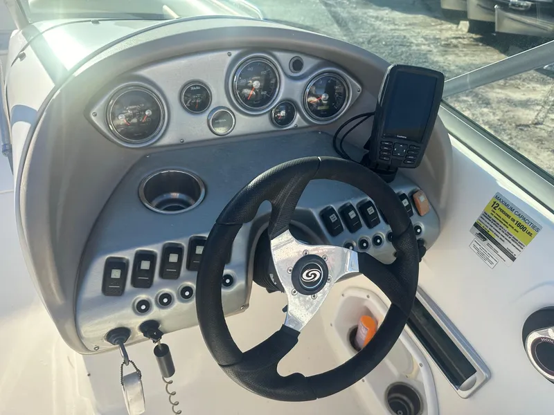Slide: The Image of 2012 Godfrey Hurricane 237 boat dashboard with steering wheel and gauges. - 5