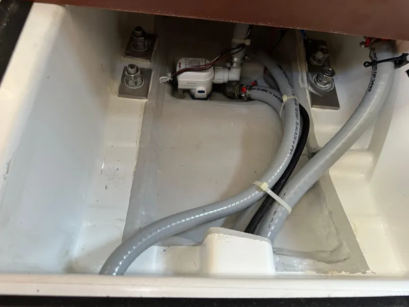 Slide: The Image of Bilge area of 2022 Jeanneau Sun Odyssey 349 with pump and hoses. - 17