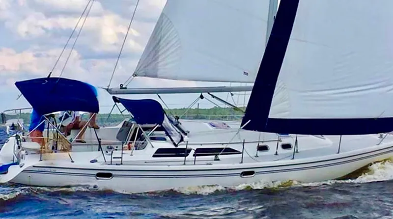 Slide: The Image of 2007 Catalina 36 MkII sailboat navigating through water with full sails. - 1