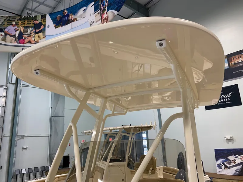 Slide: The Image of 2024 Scout 215 XSF boat with T-top in showroom. - 10