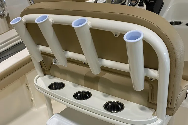 Slide: The Image of 2024 Scout 215 XSF boat rod holders and cup holders on beige seating. - 12