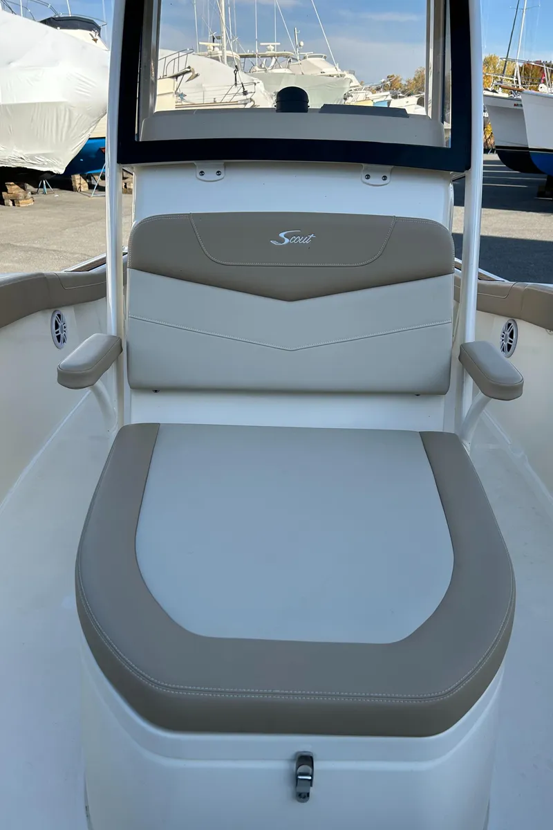 Slide: The Image of 2024 Scout 215 XSF boat interior with cushioned seating and armrests. - 6