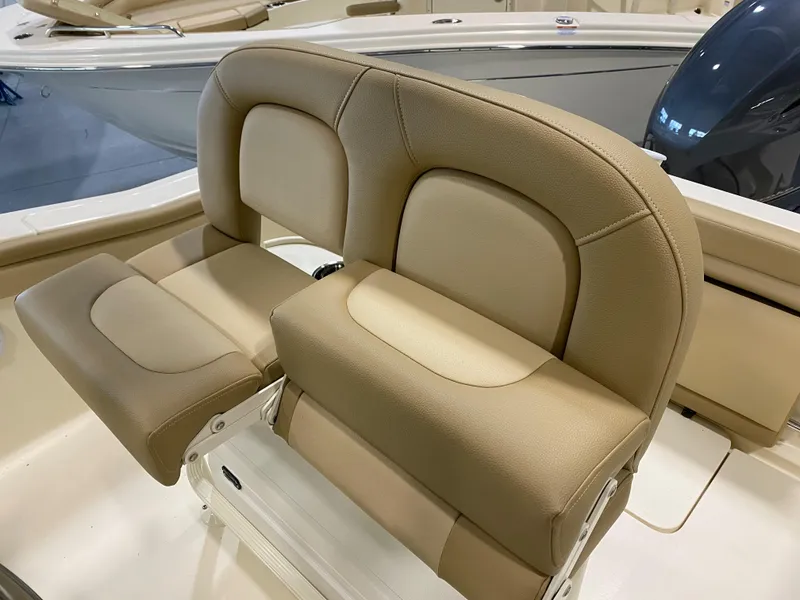 Slide: The Image of 2024 Scout 215 XSF boat with beige cushioned seating. - 7