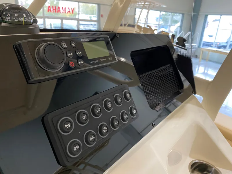 Slide: The Image of 2024 Scout 215 XSF boat dashboard with control panel and navigation instruments. - 8