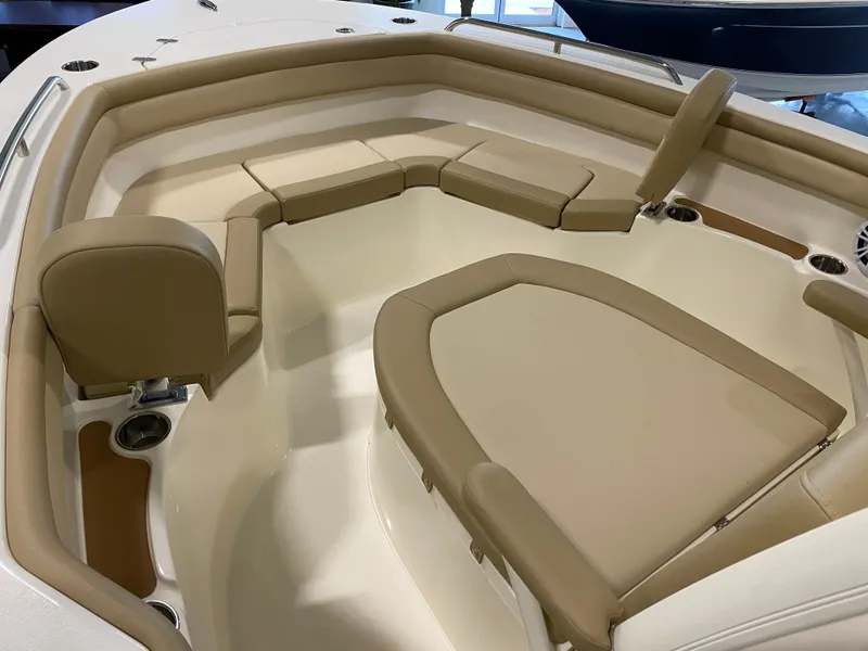 Slide: The Image of 2024 Scout 215 XSF boat interior with beige seating and cup holders. - 9