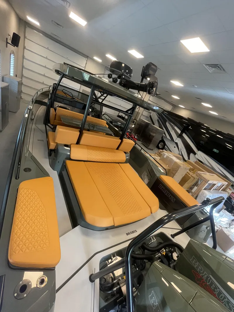 Slide: The Image of 2023 BRABUS Shadow 900 Stealth Green boat with luxurious tan seating in showroom. - 4