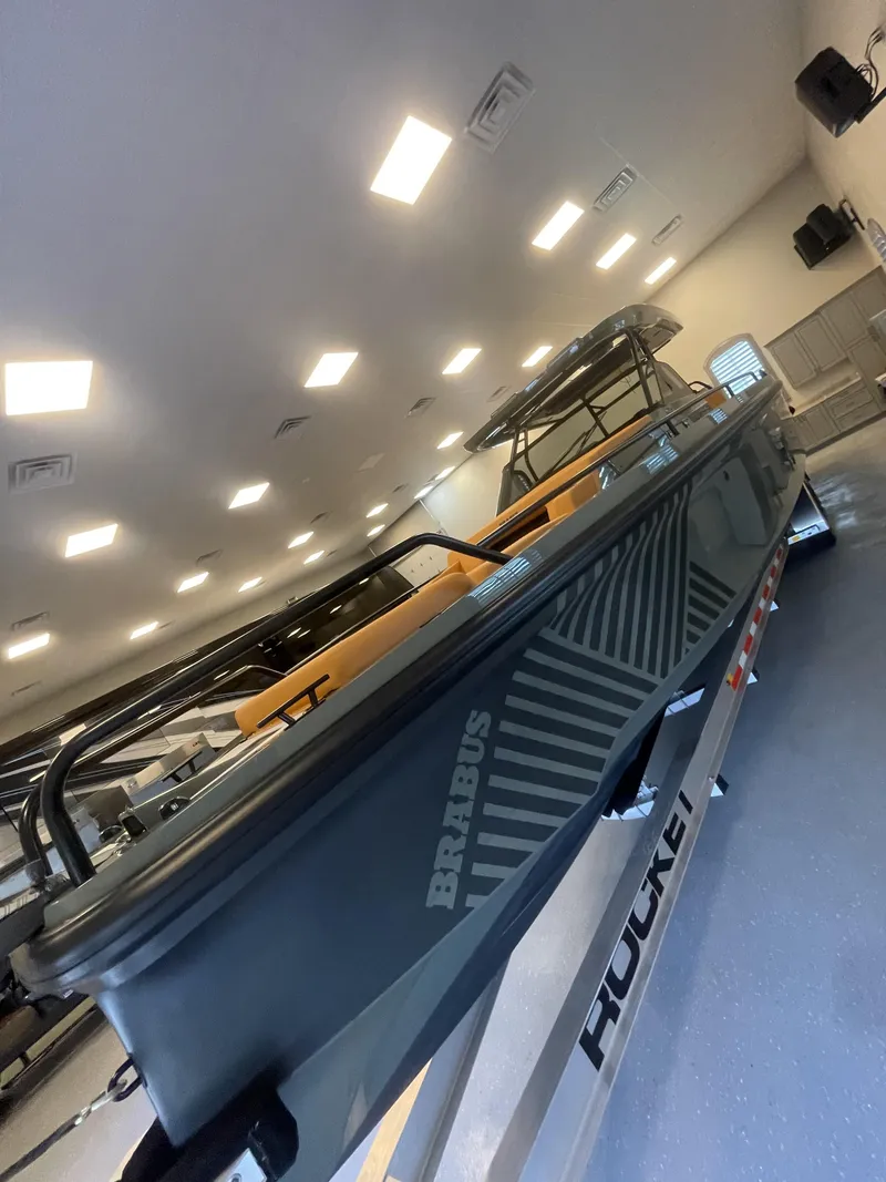 Slide: The Image of 2023 BRABUS Shadow 900 Stealth Green boat in showroom, side view. - 6