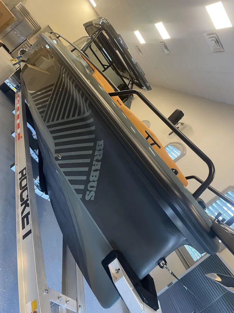 Slide: The Image of 2023 BRABUS Shadow 900 Stealth Green boat on trailer in showroom. - 7