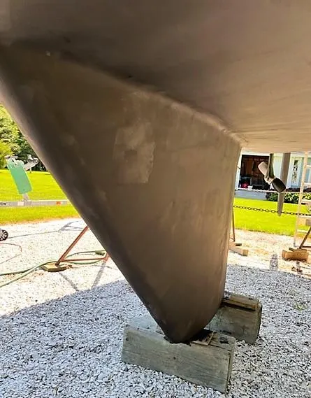 Slide: The Image of 1979 O'Day 28 sailboat keel on wooden blocks, outdoor setting. - 10