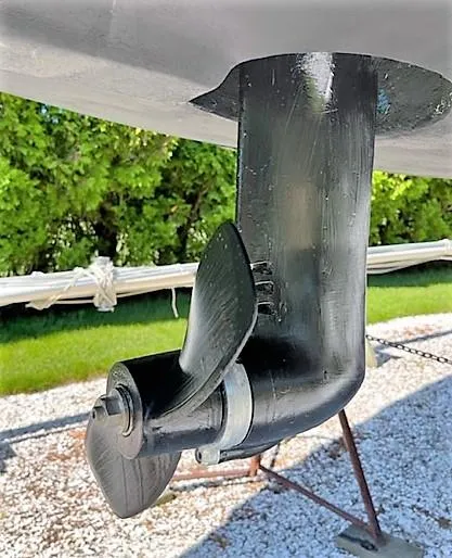 Slide: The Image of 1979 O'Day 28 sailboat propeller and rudder on display outdoors. - 12