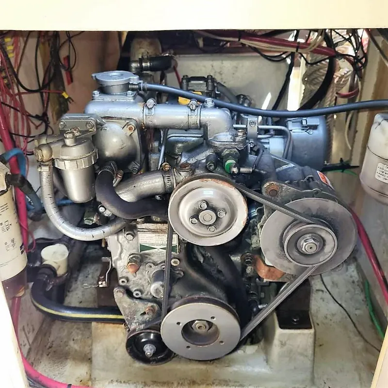 Slide: The Image of 1979 O'Day 28 engine compartment with visible belts and wiring. - 16