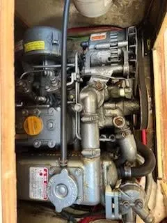 Slide: The Image of Engine compartment of a 1979 O'Day 28 sailboat, showcasing mechanical components. - 17