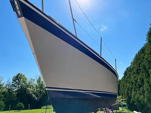Slide: The Image of 1979 O'Day 28 sailboat on land, sunny day, blue sky background. - 19