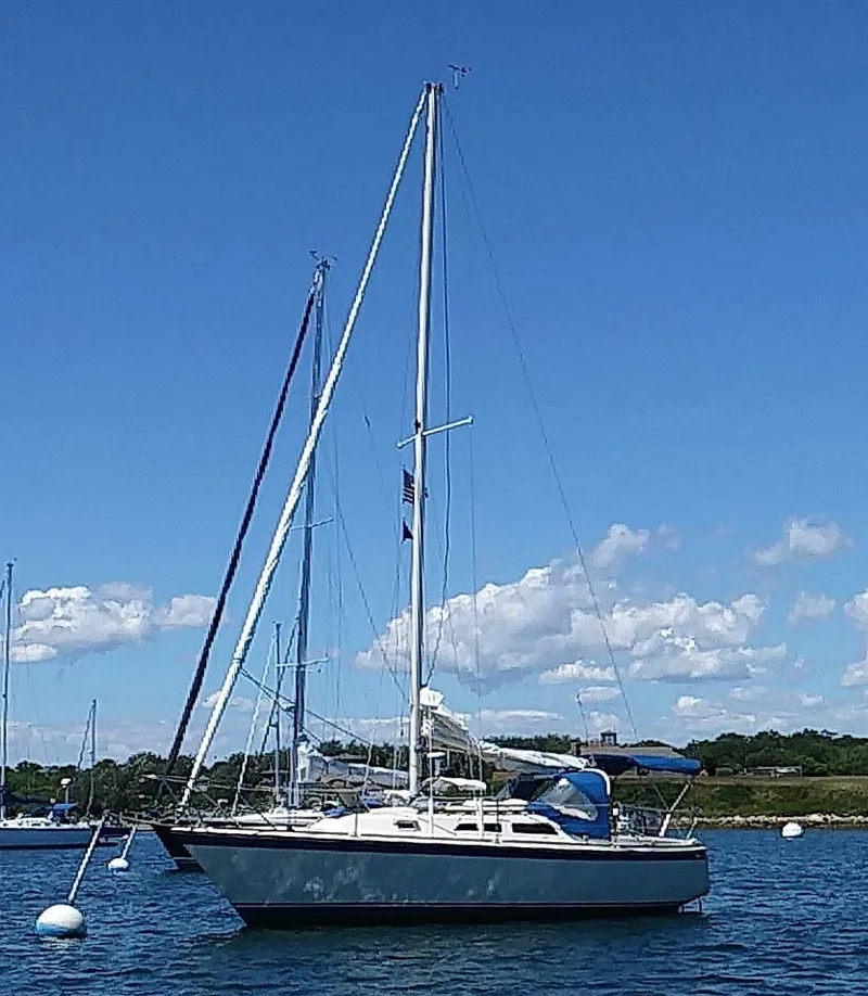 Slide: The Image of 1979 O'Day 28 sailboat anchored on a sunny day with clear blue skies. - 23