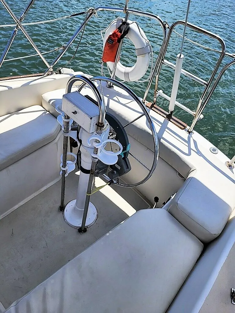 Slide: The Image of 1979 O'Day 28 sailboat cockpit with steering wheel and life preserver. - 26