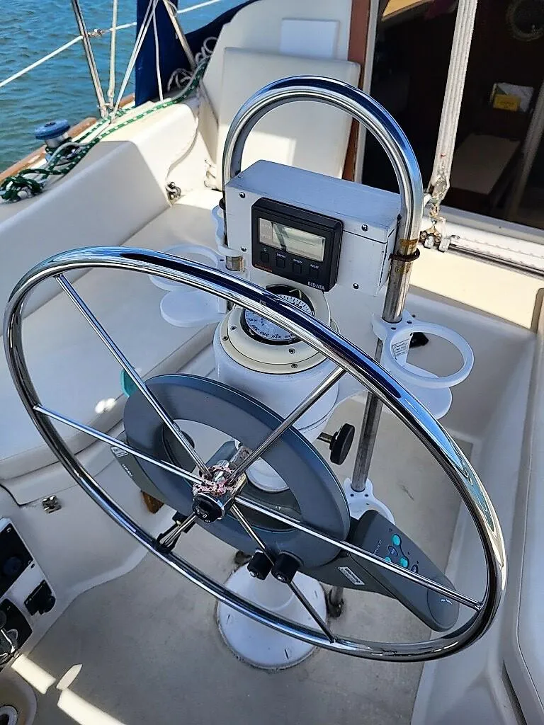 Slide: The Image of 1979 O'Day 28 sailboat cockpit with steering wheel and navigation equipment. - 27