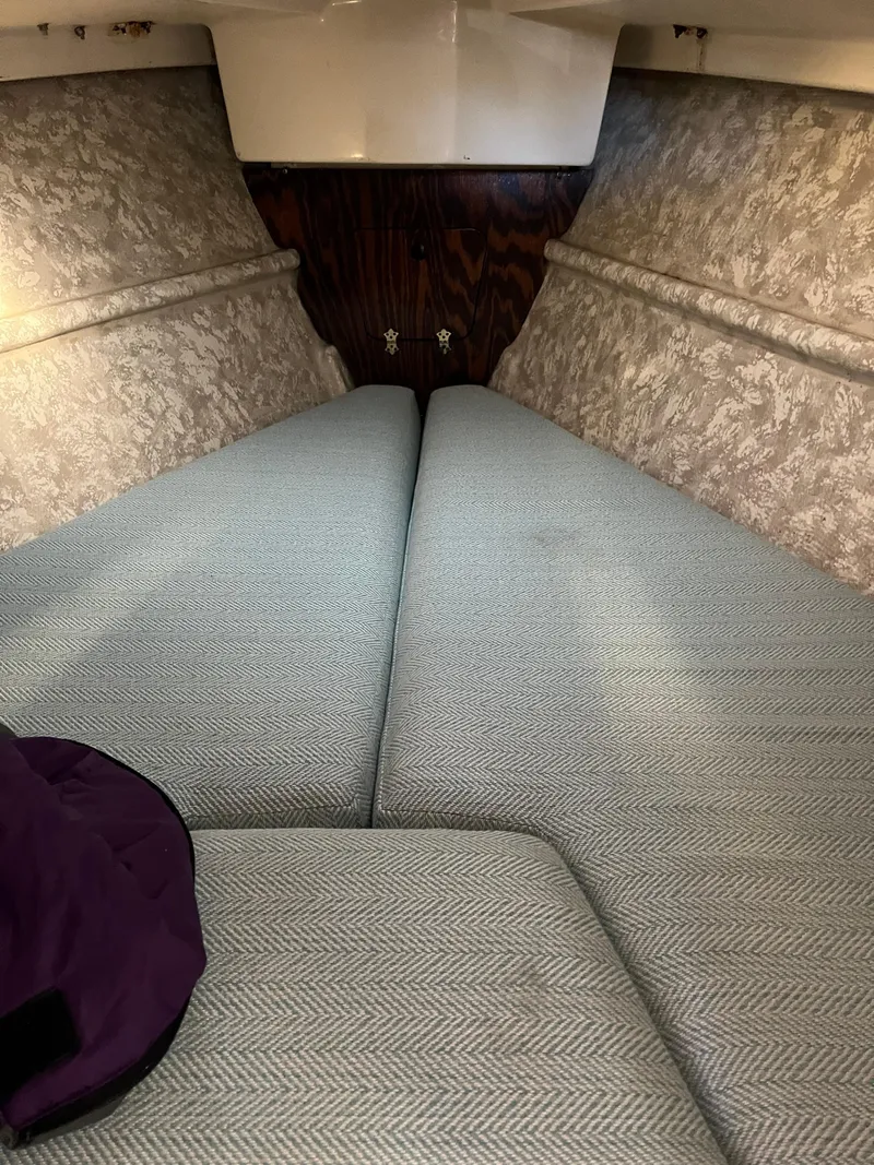 Slide: The Image of Interior cabin of a 1979 O'Day 28 sailboat with cushioned sleeping area. - 36