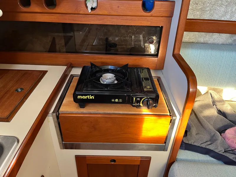 Slide: The Image of 1979 O'Day 28 sailboat interior with a portable Martin stove in the galley area. - 38