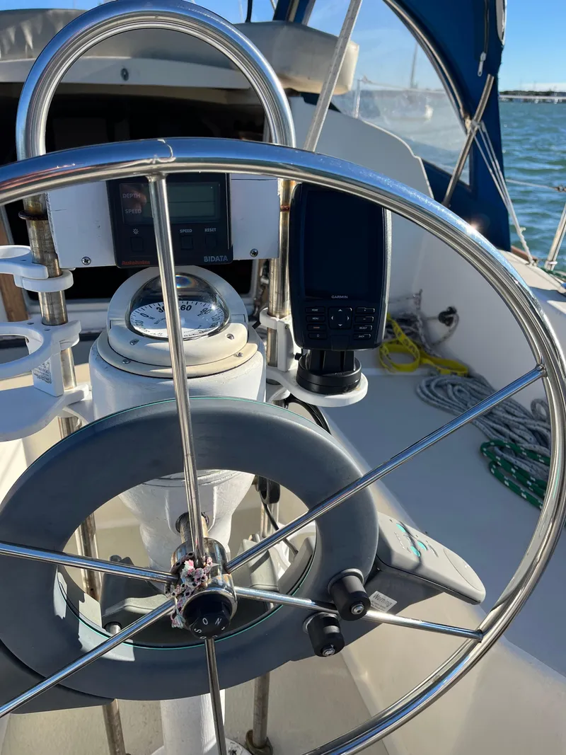 Slide: The Image of 1979 O'Day 28 sailboat helm with steering wheel and navigation equipment. - 39