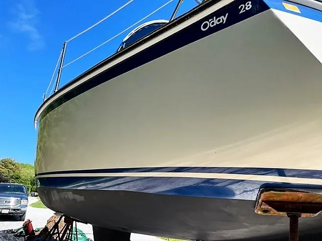 Slide: The Image of 1979 O'Day 28 sailboat on land, blue sky background. - 4
