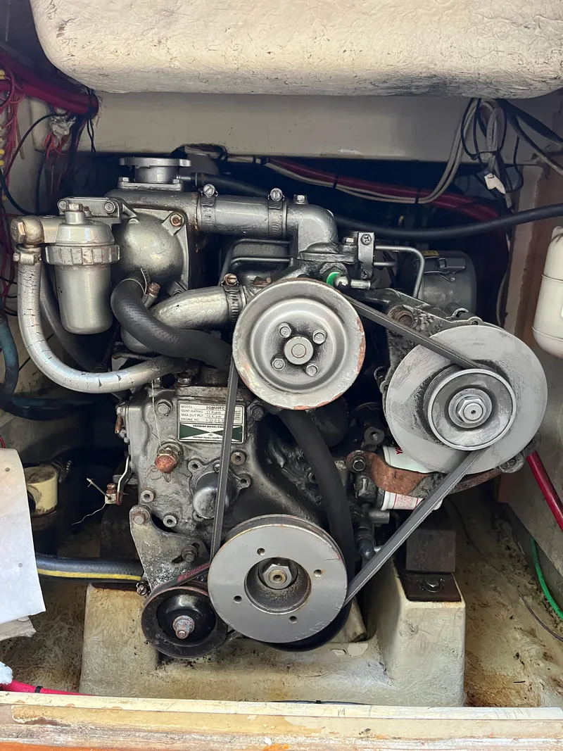 Slide: The Image of Engine of a 1979 O'Day 28 sailboat, showcasing belts and components. - 41