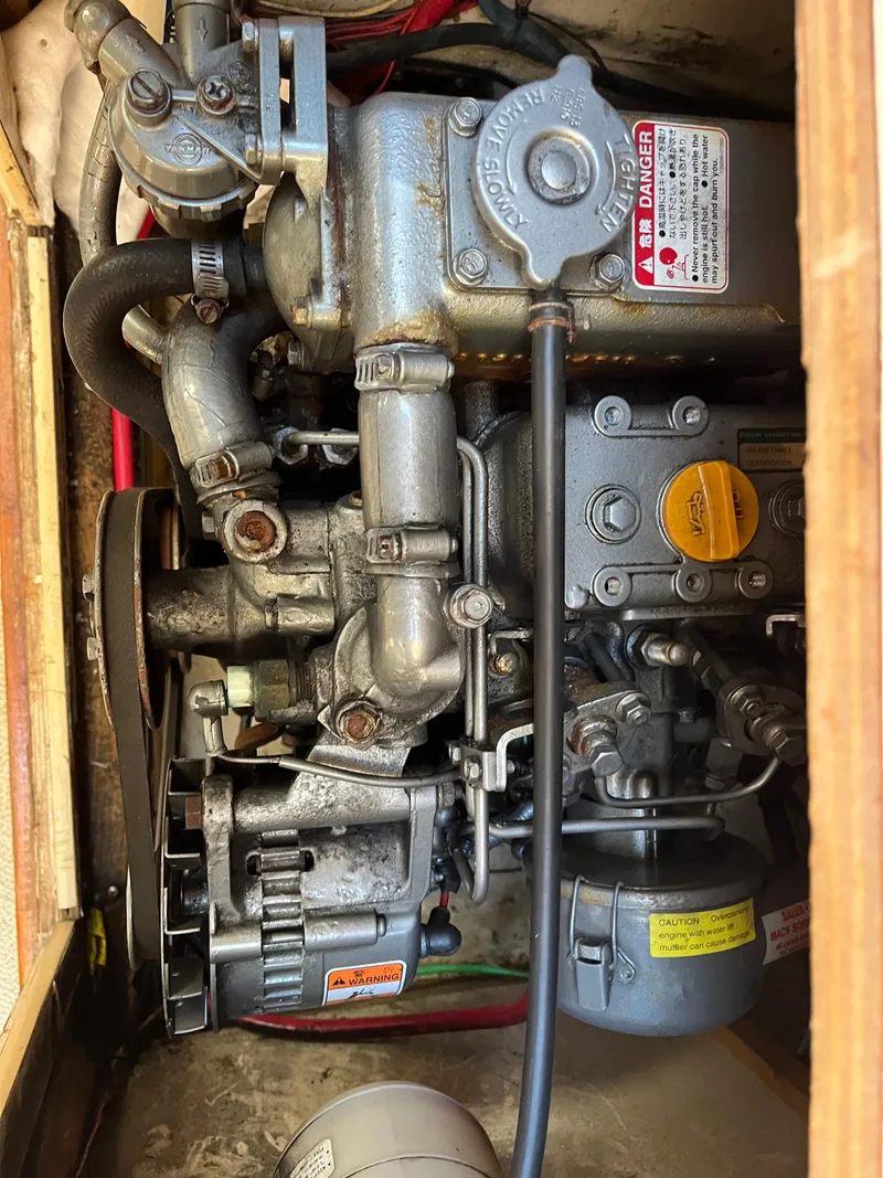 Slide: The Image of Engine of a 1979 O'Day 28 sailboat, showcasing mechanical components and labels. - 42