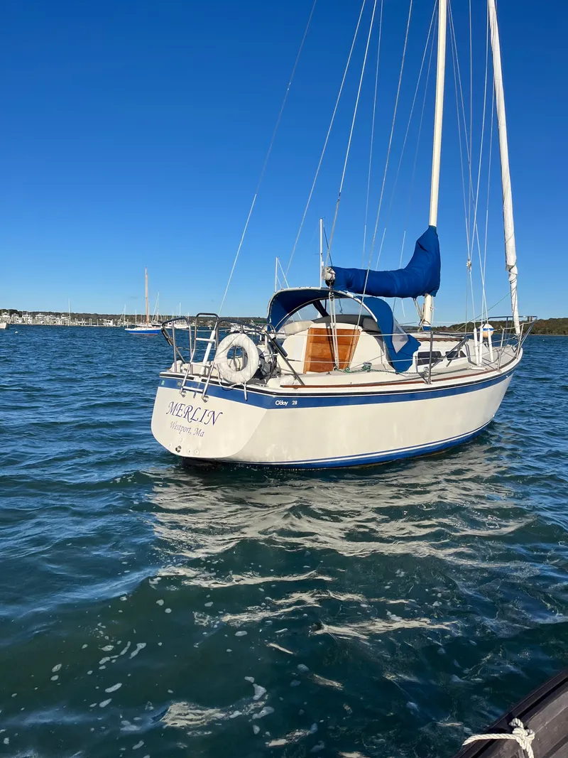 Slide: The Image of 1979 O'Day 28 sailboat on calm water under clear blue sky. - 43