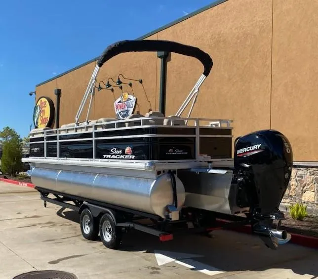 Slide: The Image of 2025 Sun Tracker SportFish 22 XP3 pontoon boat with Mercury outboard motor on trailer. - 2
