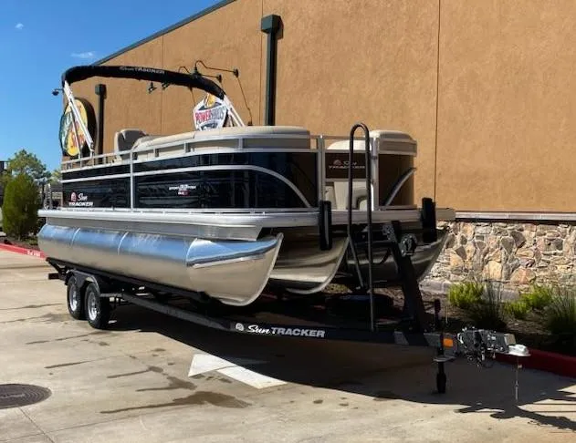 Slide: The Image of 2025 Sun Tracker SportFish 22 XP3 pontoon boat on trailer, parked outdoors. - 5