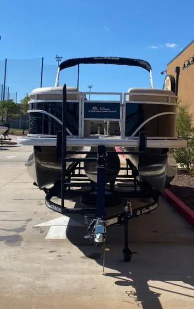 Slide: The Image of 2025 Sun Tracker SportFish 22 XP3 pontoon boat on trailer, parked outdoors. - 7