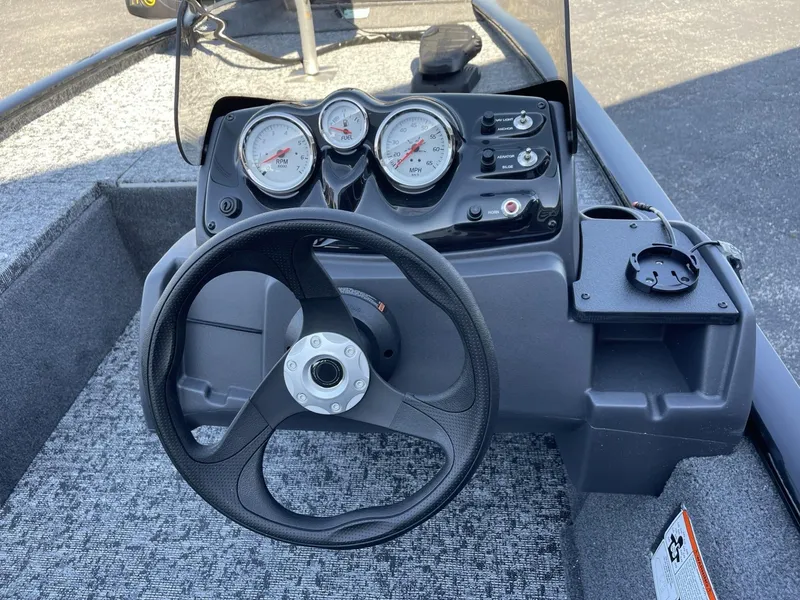 Slide: The Image of 2025 Tracker Pro 170 boat dashboard with steering wheel and gauges. - 11