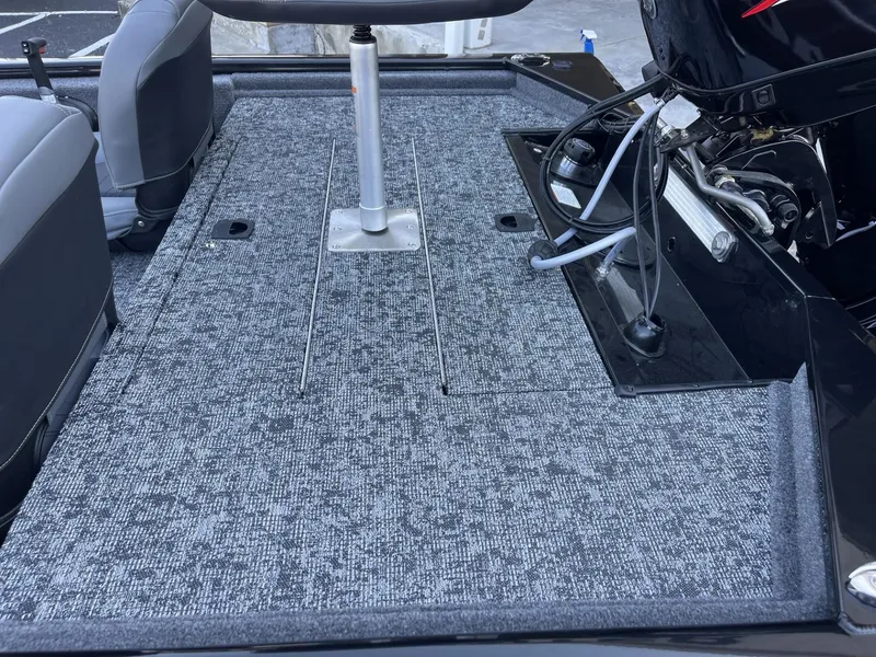 Slide: The Image of 2025 Tracker Pro 170 boat deck with motor and seating area. - 4