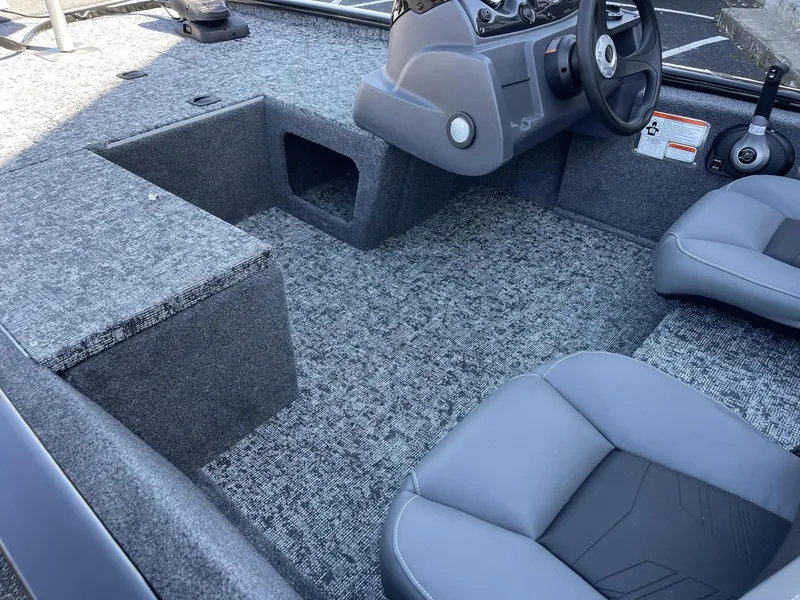 Slide: The Image of 2025 Tracker Pro 170 boat interior with gray seating and carpeted flooring. - 5