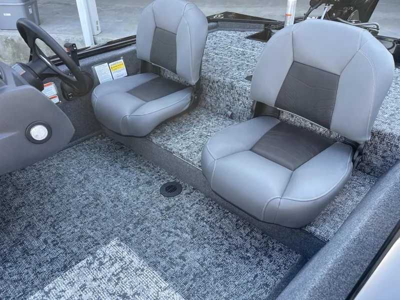Slide: The Image of 2025 Tracker Pro 170 boat interior with gray seating and carpeted flooring. - 6