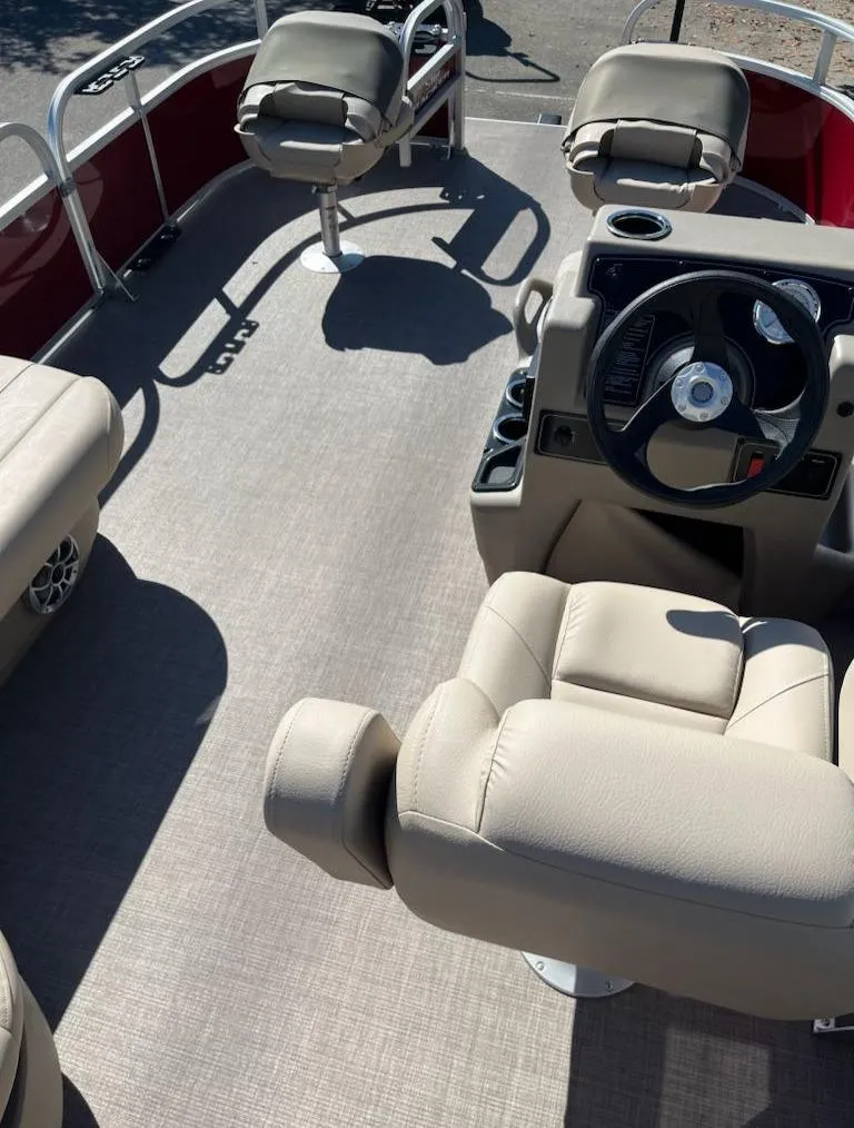 Slide: The Image of 2025 Sun Tracker Bass Buggy 16 XL Select interior with beige seating and steering console. - 4