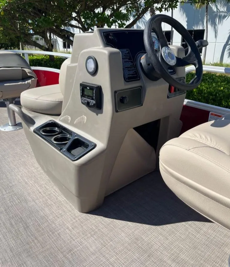 Slide: The Image of 2025 Sun Tracker Bass Buggy 16 XL Select boat console with steering wheel and cup holders. - 5