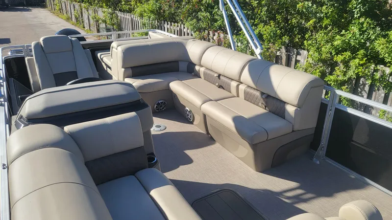Slide: The Image of 2025 Sun Tracker Sportfish 24 XP3 pontoon boat with spacious seating and modern design. - 3